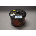 A William Moorcroft lidded pot. Stamped to base 'Burslem 107' and signed. AF