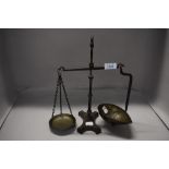 A set of Victorian apothecary or similar balance scales, cast iron frame with brass pans