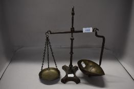 A set of Victorian apothecary or similar balance scales, cast iron frame with brass pans