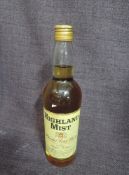 A bottle of Highland Mist Blended Scotch Whisky, 25FL.0zs, 65.5 %, under proof, having gold coloured