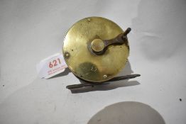 A vintage brass, crank wind eaton and deller fly reel missing its ivory or bone handle