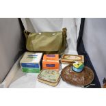 A canvas bag containing an assortment of vintage fishing tackle including hooks weights and line and