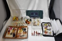 A good collection of salmon flies in 7 containers and a bag marked House of hardy