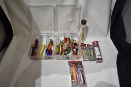 A selection of fishing lures and spinners some in original packaging