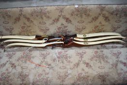 A large quantity of Archery equipment including 3 cased sets of arrows and 4 bows including 3 by