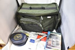 A clean Wychwood compact carryall Fishing bag containing a large selection of fishing tackle