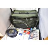 A clean Wychwood compact carryall Fishing bag containing a large selection of fishing tackle