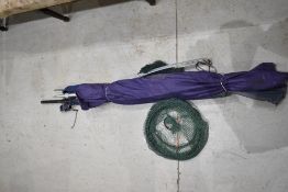 A Daiwa Gamma 12ft rod , A fiberglass unmarked rod , 2 nets and a fishing umberella