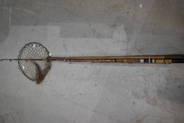 A shakespeare boat rod , an Abu fly rod and a intage wooden handled landing net