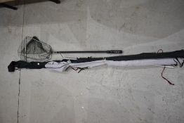 An Abu Garcia Conlon 300 8ft 2 pc rod and a Vintage 2pc Shore Caster rod both in soft sleeves