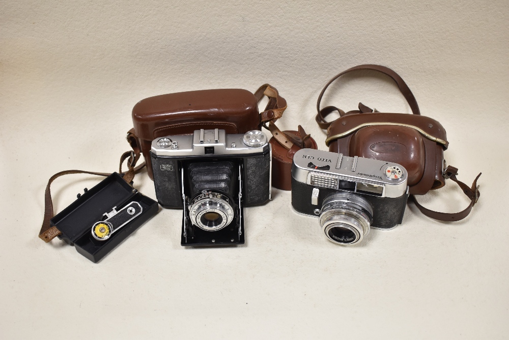 Two cameras. A Zeiss Ikon folding camera and a Voightlander Vito CLR