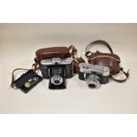 Two cameras. A Zeiss Ikon folding camera and a Voightlander Vito CLR