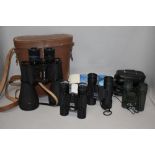 A pair of Underman Supervue 12 x 50 binoculars and three pairs of sport pocket binoculars 8x21,