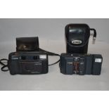 Two Canon cameras. A Canon Sureshot Multitele with Canon 35/60 1:3,5-5,6 lens and Canon MC with