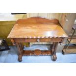A pitch pine dressing or sewing table having scalloped top with under draw and turned supports.