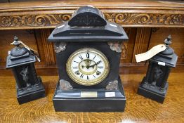 A Victorian black slate and varigated marble mantel clock, the circular dial with Roman hours and