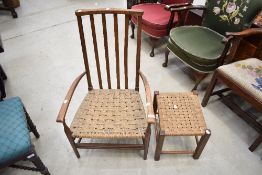 A traditional low arm chair having Beech wood frame with rush seat and matching foot stool