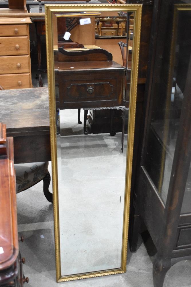 A gilt framed and bevelled wall mounted dressing mirror