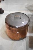 An antique copper cheese kettle with lid and wrought iron handle