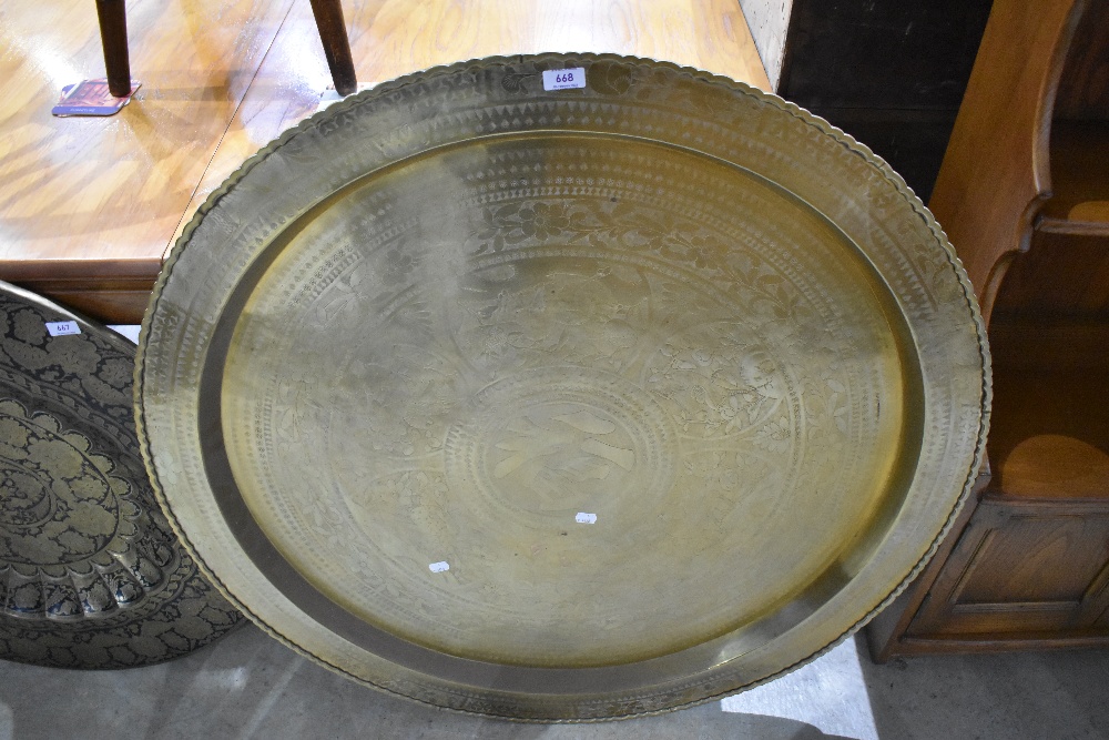 A large brass tray of Oriental design having wildlife panels, diameter approx. 97cm