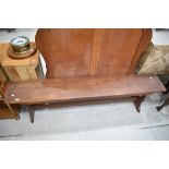 A traditional low bench or pew in stained oak