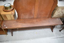 A traditional low bench or pew in stained oak