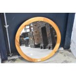 A modern circular pine mirror