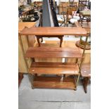 A mid century shelf unit with brass frame and Mahogany shelves.