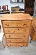 A modern Pine chest of five drawers, also having a fitted safe with key into one drawer.