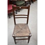 A Victorian oak bedroom chair having rush seat