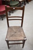 A Victorian oak bedroom chair having rush seat