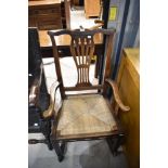 A farm house style rocking chair having oak frame with woven fibre seat