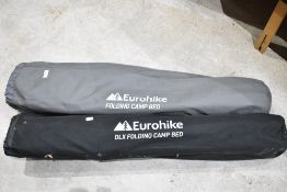 Two Eurohike folding camp beds, with material carry bags