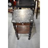 A Victorian pot stand with turned legs and black marble top.