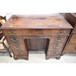 A late Victorian knee hole desk with flame Mahogany veneer top