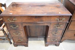 A late Victorian knee hole desk with flame Mahogany veneer top