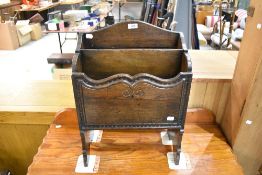 A Victorian Arts and Crafts style magazine rack with shaped front.