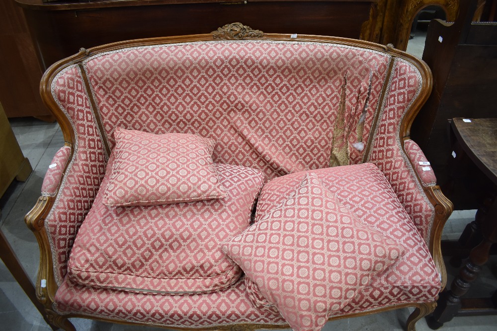 A French Louis XV style settee, having carved and moulded show frame and patterned material