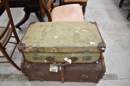 A Vintage ribbed canvas travel trunk sold along with a green canvas and leather suitcase