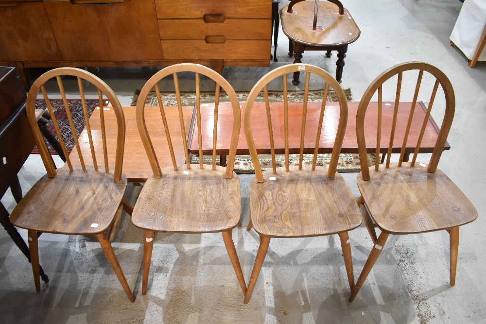 A set of four Ercol dining chairs with Elm seats and hoop backs.