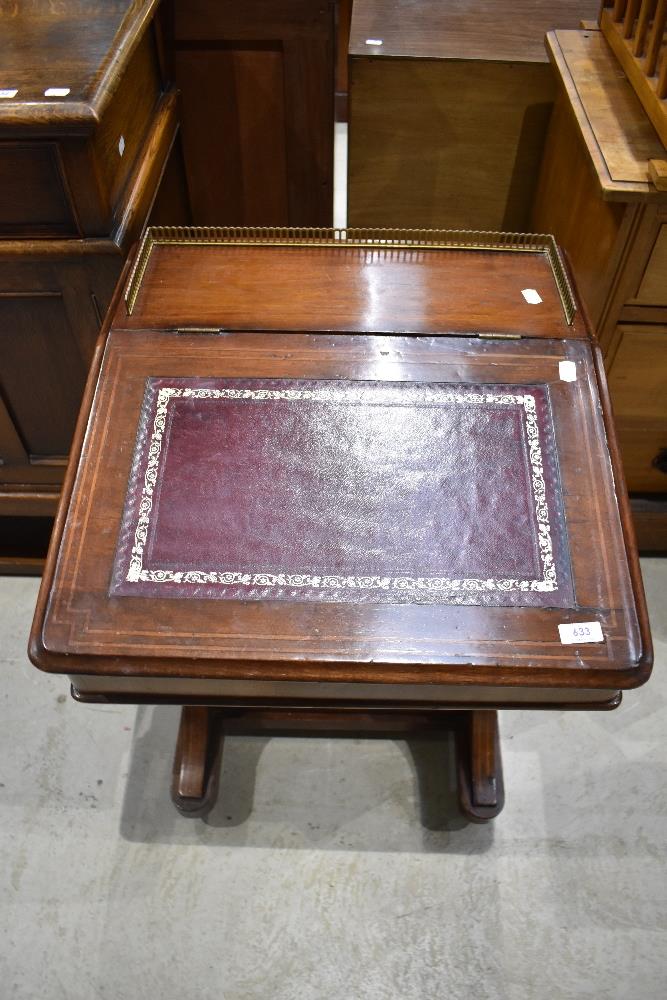 A late 19th century walnut Davenport, having brass three quarter gallery, stained leather skiver and