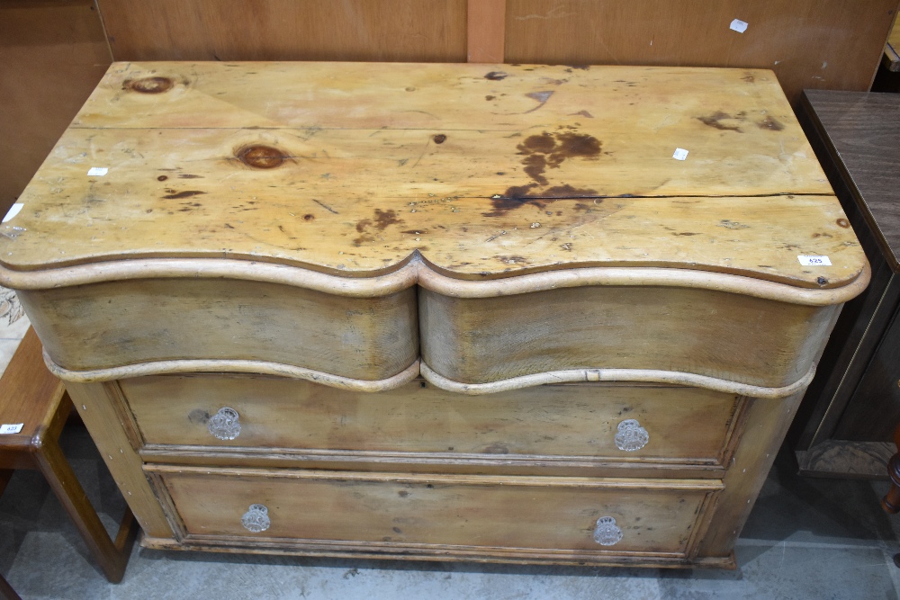 A reclaimed pine chest of drawers, the serpentine fronted rectangular top above two blind frieze