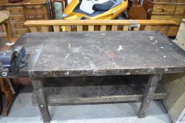 A traditional industrial wooden work bench with Record bench vice