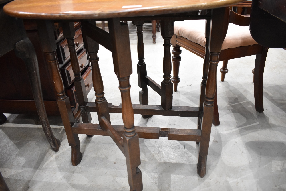 An early 20th century oak Sutherland table, of traditional design with turned gated supports and - Image 2 of 2