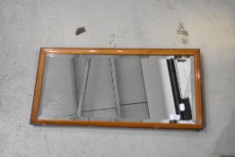 A vintage wall mirror, labelled 'Sadlers' , approx. 69 x 35cm