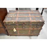 An antique travel trunk strong box with wooden and leather banding over painted canvas. 110cm x 65cm