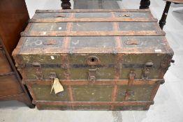 An antique travel trunk strong box with wooden and leather banding over painted canvas. 110cm x 65cm