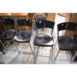 A set of four chrome and plastic kitchen bar stools