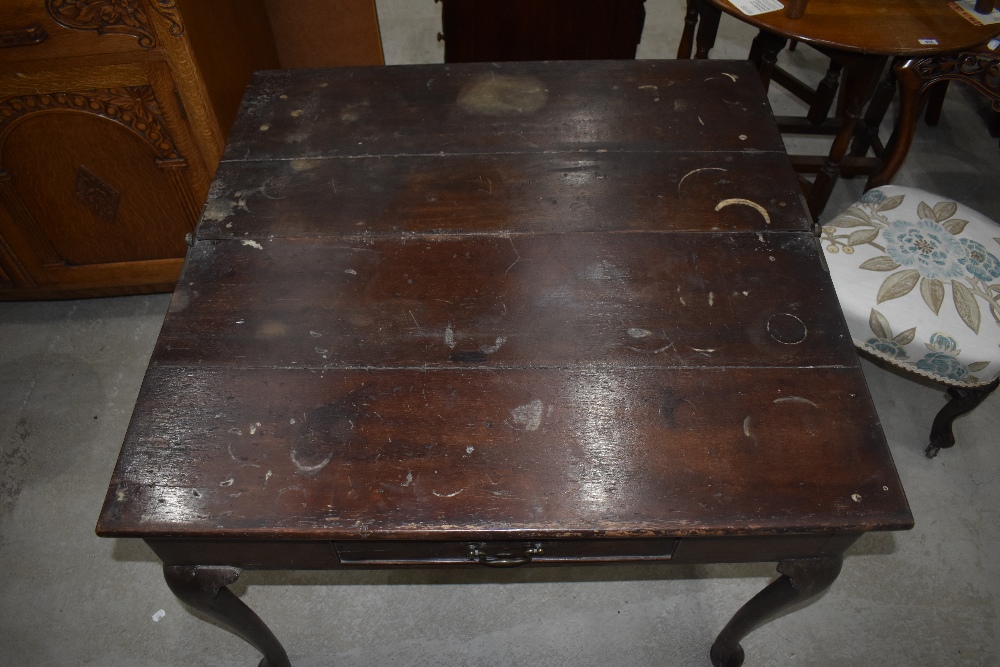 A George III oak fold over side table, the hinged rectangular top above a short frieze drawer and - Image 4 of 4