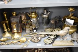 A selection of metal hardware including candle sticks, cocktail shaker, horse brasses and pheasant